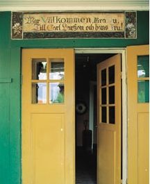 an open door to a green and yellow building