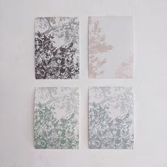 four square pieces of paper with different designs on them, all in shades of grey and white