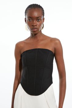 Experience Elevated Options In Our Corset Top, With A Fitted Silhouette, A Sleek, Minimal Design, And A Cropped Corset Style. The Structured, Boned Design Takes Inspiration From Classic Tailoring, And The Strapless Neckline Makes A Piece Perfect For Layering And Styling At Any Occasion. Style It With A Maxi Skirt Or Tailored Trousers For A Look Ideal For Wedding Guest Days And Occasion Nights, Then Style With Wide Leg Trousers For A More Casual Approach. Figure Form Bandage Corset Detail Knit To Elegant Strapless Elastane Top, Sleek Strapless Evening Tops, Fitted Bandage Top For Night Out, Stretch Bandage Bandeau Top, Sleek Structured Evening Tops, Bandage Evening Top For Summer, Bandage Top For Summer Evenings, Bandage Tops For Evening In Summer, Summer Evening Bandage Top