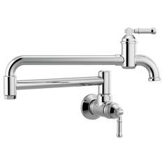 two faucets on the wall, one is chrome