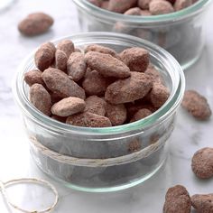 two glass bowls filled with dog food on top of a table