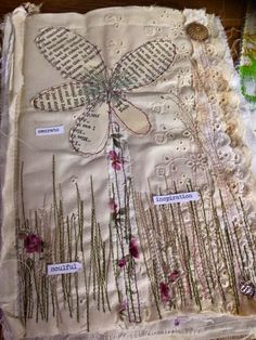 a piece of cloth with flowers on it and some words written in the middle,