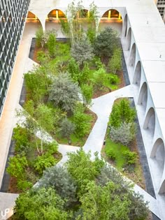 an aerial view of a courtyard with trees and plants