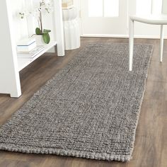 a large gray rug on the floor in a living room