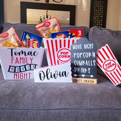 popcorn boxes with movie tickets on them sitting on a couch