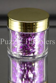 two jars filled with purple and gold glitter