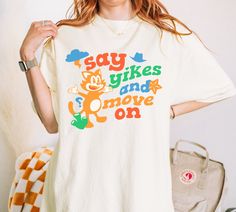 "Say Yikes and Move On" T-Shirt, a perfect blend of silly and stylish! Designed for those who love kidcore and clowncore aesthetics, this anxiety shirt is all about turning life's little mishaps into lighthearted moments. Whether you're a fan of funny shirts or just need a reminder to keep things light, this t-shirt is your new go-to for adding a splash of fun to your wardrobe. Say yikes, wear a smile, and move on with style! The soft-washed, garment-dyed fabric brings extra coziness to your war Weird Shirts Graphic Tees, Clown Core Outfit, Weirdcore Clothes, Kidcore Shirt, Weirdcore Outfits, Kidcore Clothes, Kidcore Clothing, Clown Core, Silly Clothes