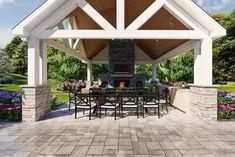 a covered patio with tables and chairs under an awning over the fire pit area