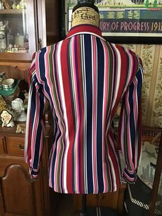 "Vintage 1970's Polyester, long sleeve blouse. Great multi-color stripes. Colors are brighter in person than show up in pictures. Buttons down the front. The label is *KOLORTRON* By Koret Of California. *SCROLL DOWN FOR MORE INFORMATION* **I DO COMBINE SHIPPING** CONDITION: One small Gold spot on the lower, front below the buttonhole near the hemline (SEE PIX). MEASURES: Bust~36\" Waist~32\" Hips~40\" Sleeve length~21 1/2\" Shoulder seam to shoulder seam~14 1/2\" Back of collar to bottom~25\" *W Bermuda Bags, 1970s Blouse, Vintage Clothing Boutique, Color Stripes, Show Up, The Label, 1970s, Sleeve Blouse, Blouses For Women