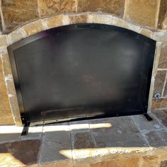 a flat screen tv sitting on top of a stone fireplace