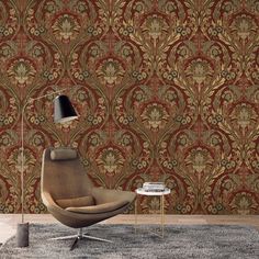 a chair and table in front of a wallpapered room with a lamp on it