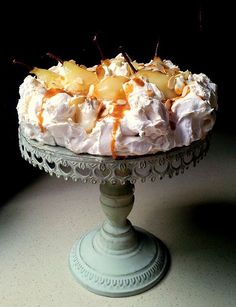 there is a cake that has been topped with whipped cream and pineapple toppings