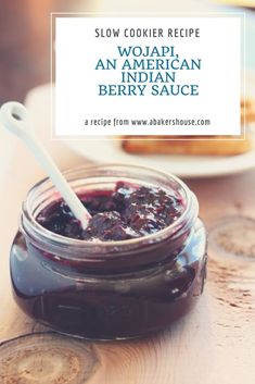 a jar filled with jam sitting on top of a wooden table