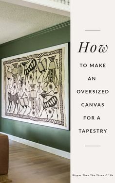 a living room with green walls and a painting on the wall that says how to make an oversized canvas for a tapestry