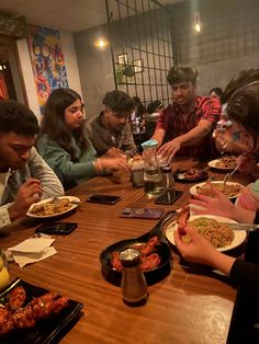 a group of people sitting around a table eating food