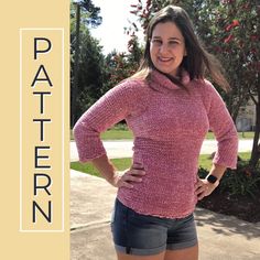 a woman standing in front of a tree with her hands on her hips, wearing shorts and a pink sweater