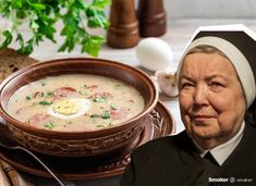 an old woman is sitting in front of a bowl of soup with eggs on top