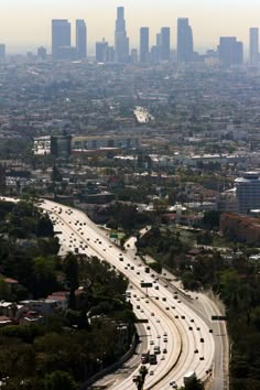 black and white photograph of freeway with city skyline in the background, los angeles