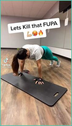 a woman is doing push ups on a mat