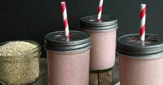 three mason jars filled with pink smoothies and topped with straws