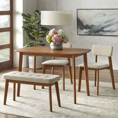 a dining room table with two chairs and a bench