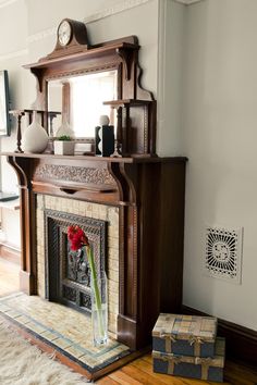 a living room with a fireplace and mirror