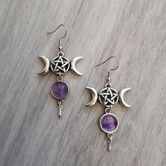 Invoke the power of the divine feminine with these beautiful triple moon earrings! Featuring pentagrams and amethyst crystals, they offer powerful spiritual protection against unwanted energies. Material: Metal; Amethyst crystal Earring Type: Ear hooks Earring Size: 6.2cm long (2.4 inches) Recommended Occasions & Uses: Wiccan protection amulet, witchy jewelry, pagan fashion, Wiccan gift. Package Contents: 1x pair of earrings Wicca Pentagram, Spiritual Elevation, Wiccan Earrings, Crescent Moon Jewelry, Wiccan Jewelry, Gothic Earrings, Witch Magic, Witch Jewelry, Pagan Jewelry