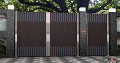 an open gate in front of a large tree and checkered tile floored area