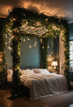 a bed covered in greenery with lights hanging from it's headboard and canopy