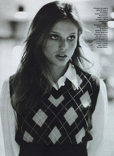 a woman with long hair is wearing a sweater and posing for a magazine cover photo