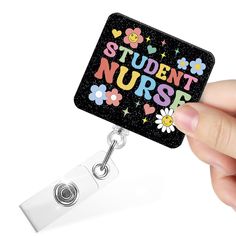 a person holding a badge with the words student nurse on it and daisies all over them