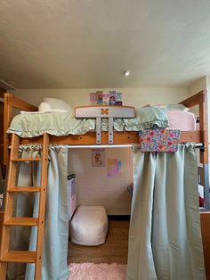 there is a bunk bed with curtains on the top and below it, next to a ladder