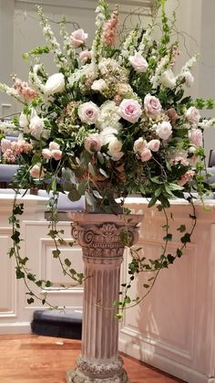 a vase filled with flowers on top of a wooden table