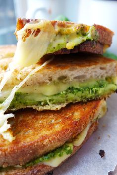 a close up of a sandwich with broccoli and cheese