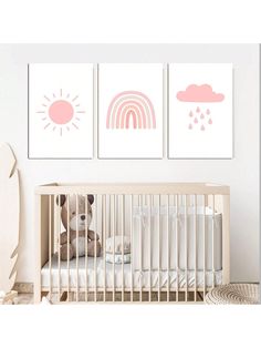 a baby's nursery room with three prints on the wall