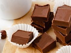 several pieces of chocolate sitting next to each other on top of a wooden cutting board