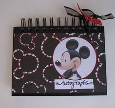 a black and white mickey mouse calendar with red bows on it's head, hanging from the wall