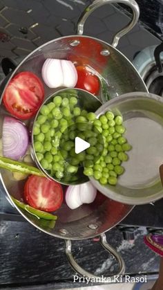 peas, tomatoes and onions are in a pot on the stove