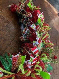 a red and green christmas wreath on the floor