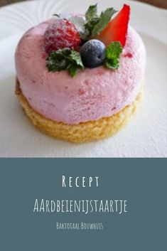 a close up of a pastry on a plate with berries and mints in it