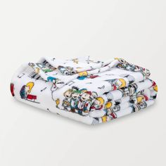 three baby swaddles on top of each other in white with cartoon characters printed