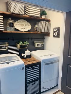 a washer and dryer sitting next to each other in a room with shelves on the wall