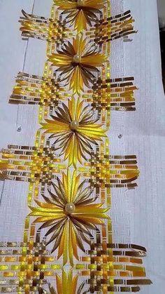 a table cloth with yellow and brown designs on it's edges, in the shape of a christmas tree