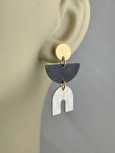 "These earrings have a stylish geometric minimalist look with push back stud posts. The glossy gold is 18 K gold over brass. They are glossy because they're rack plated. This means that the pieces are hand hung so they receive the optimal amount of coverage. The black is oxidized metal. The silver is a matte silver alloy over brass which is a white silver. The white silver goes well with shiny gold and black. The different finishes enhance each other to make an interesting mix of metals. We offe Modern Dangle Plug Earrings, Minimalist Earrings Gold, Mixed Metal Earrings, Earrings Geometric, Half Circle, Earrings Minimalist, Metal Earrings, Geometric Earrings, Circle Earrings