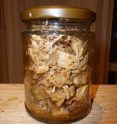 a jar filled with food sitting on top of a wooden table