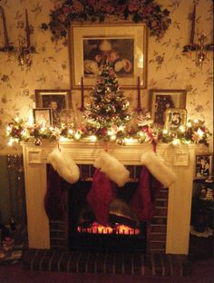 a fireplace decorated with stockings and christmas lights