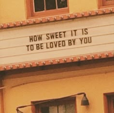 a sign on the side of a building that says how sweet it is to be loved by you