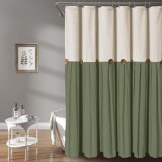 a bath room with a shower curtain and a table in front of the tubtub