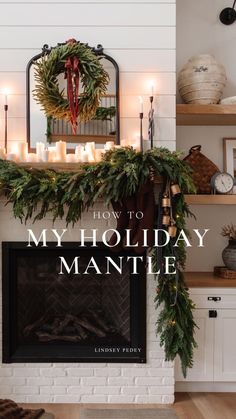 a fireplace decorated for christmas with candles and greenery on the mantel above it