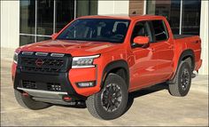 a red truck parked in front of a building